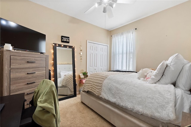bedroom featuring ceiling fan, light colored carpet, and a closet