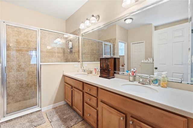 full bathroom featuring double vanity, a sink, and a stall shower