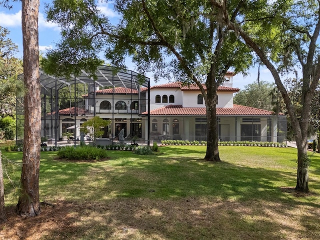 1716 Greystone Ct, Longwood, FL 32779 - rear view of property with stucco siding, a lanai, a yard, and a tile roof