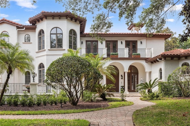 1716 Greystone Ct, Longwood, FL 32779 - mediterranean / spanish house with a tile roof, french doors, a balcony, and stucco siding