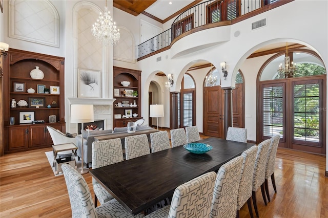 1716 Greystone Ct, Longwood, FL 32779 - dining space featuring light wood-style floors, built in features, a high ceiling, and a chandelier