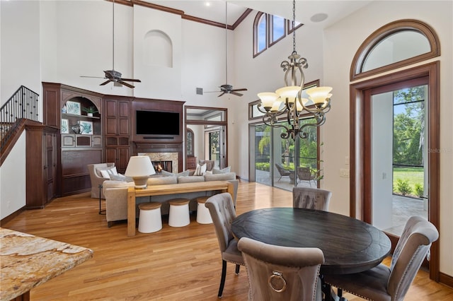 1716 Greystone Ct, Longwood, FL 32779 - dining space featuring light wood finished floors, ceiling fan with notable chandelier, and a healthy amount of sunlight