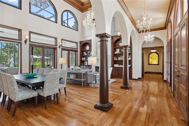 1716 Greystone Ct, Longwood, FL 32779 - dining area with crown molding, arched walkways, a high ceiling, and a chandelier