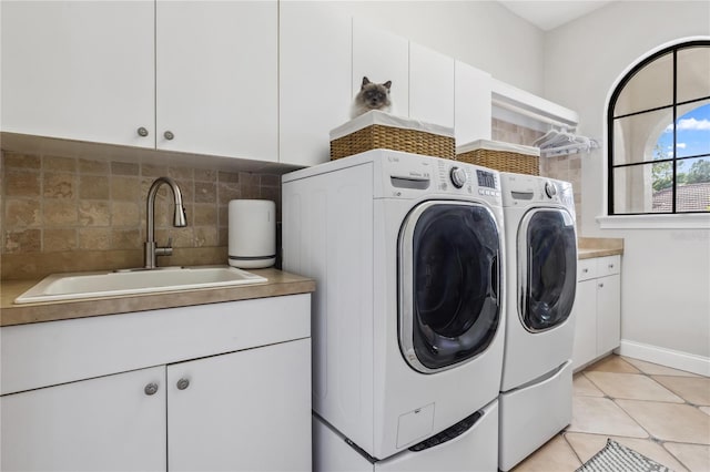 1716 Greystone Ct, Longwood, FL 32779 - laundry area featuring cabinet space, a sink, separate washer and dryer, baseboards, and light tile patterned floors