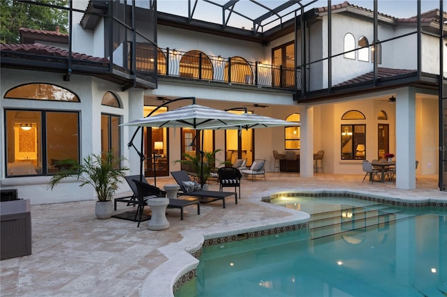 1716 Greystone Ct, Longwood, FL 32779 - back of house featuring stucco siding, an outdoor pool, a patio area, a balcony, and a ceiling fan
