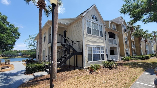 1071 S Hiawassee Rd Unit 1211, Orlando, FL 32835 - view of home's exterior with a water view and stairway