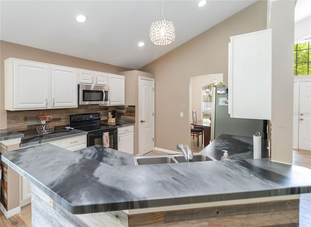 kitchen with white cabinets, appliances with stainless steel finishes, a sink, recessed lighting, and tasteful backsplash