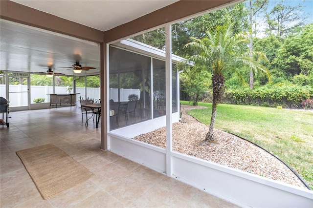 unfurnished sunroom with a ceiling fan