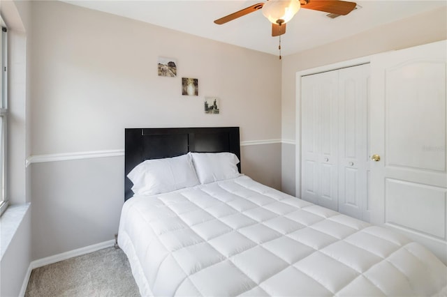 bedroom with a closet, a ceiling fan, carpet, and baseboards