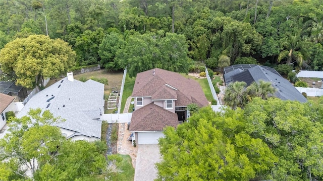birds eye view of property featuring a view of trees