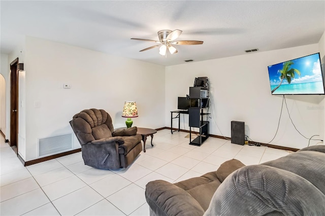 living room with visible vents, baseboards, ceiling fan, and light tile patterned floors
