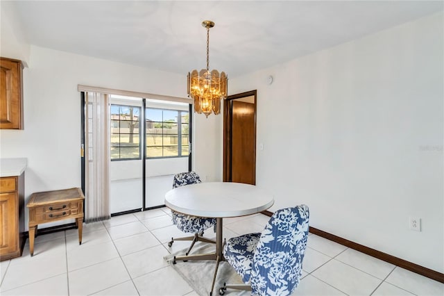 dining area with baseboards, a chandelier, and light tile patterned floors