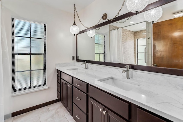 bathroom featuring tile patterned flooring, a sink, curtained shower, and double vanity