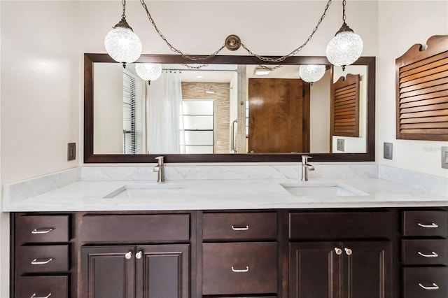 bathroom featuring a sink and double vanity