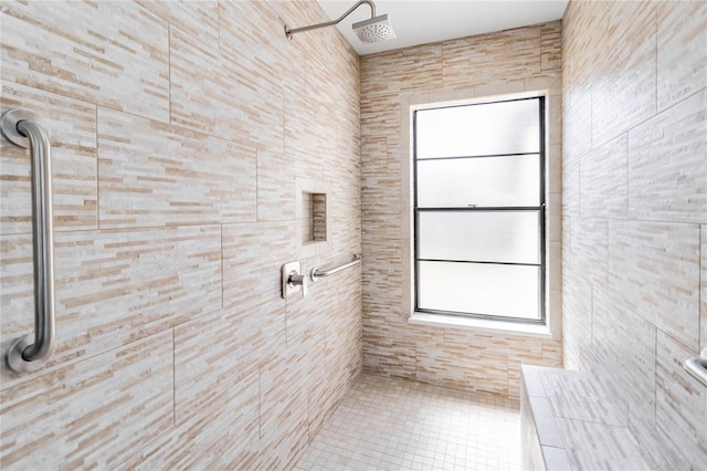full bathroom featuring tile patterned floors and a tile shower