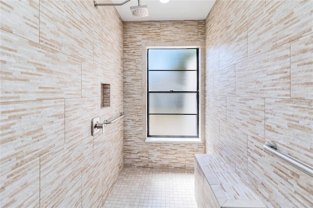 bathroom with tile patterned floors, tile walls, and tiled shower