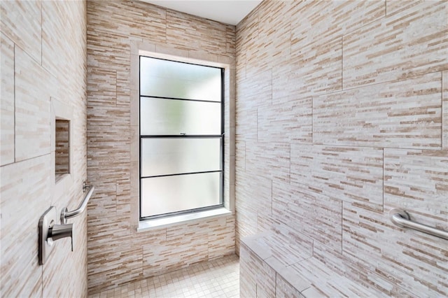 bathroom with tiled shower