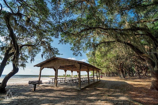 surrounding community with a water view and a gazebo