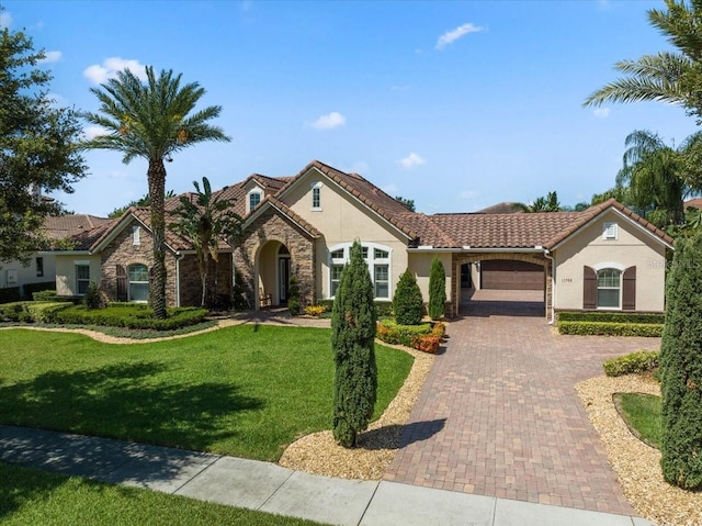 11502 Waterstone Loop Dr, Windermere, FL 34786 - view of front of home with stucco siding, decorative driveway, a garage, and a front yard