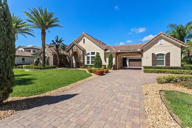 11502 Waterstone Loop Dr, Windermere, FL 34786 - view of front facade featuring stucco siding, decorative driveway, a garage, and a front lawn