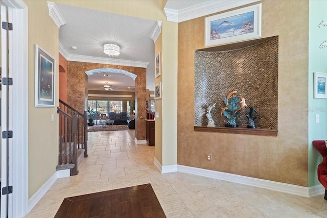 11502 Waterstone Loop Dr, Windermere, FL 34786 - hallway with arched walkways, baseboards, crown molding, stairway, and stone tile floors