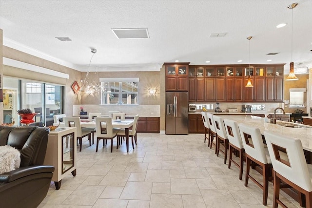 11502 Waterstone Loop Dr, Windermere, FL 34786 - dining area featuring recessed lighting, ornamental molding, stone tile flooring, and a textured ceiling