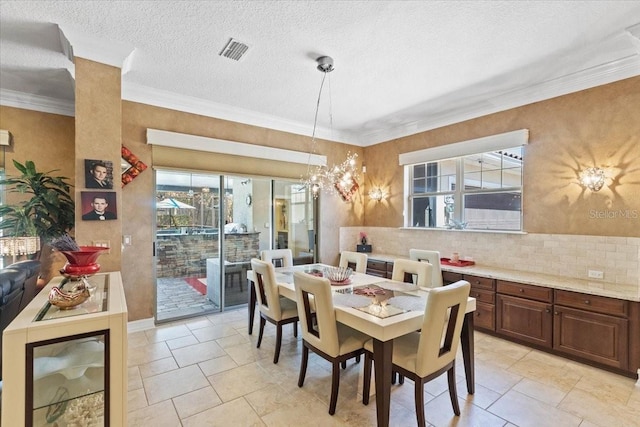 11502 Waterstone Loop Dr, Windermere, FL 34786 - dining space with plenty of natural light, a chandelier, ornamental molding, and a textured ceiling
