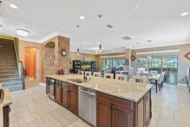 11502 Waterstone Loop Dr, Windermere, FL 34786 - kitchen with dishwasher, a sink, wine cooler, arched walkways, and light stone counters