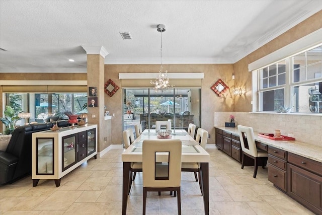 11502 Waterstone Loop Dr, Windermere, FL 34786 - dining area featuring ornamental molding, a chandelier, a textured ceiling, baseboards, and a desk