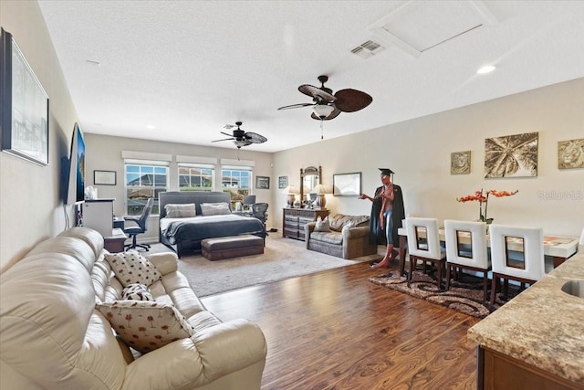 11502 Waterstone Loop Dr, Windermere, FL 34786 - living area with dark wood-style flooring, a textured ceiling, a ceiling fan, attic access, and recessed lighting