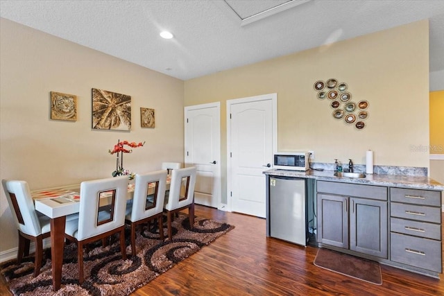 11502 Waterstone Loop Dr, Windermere, FL 34786 - dining area featuring dark wood-style floors and a textured ceiling