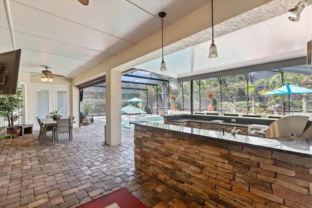 11502 Waterstone Loop Dr, Windermere, FL 34786 - view of patio / terrace featuring exterior kitchen, an outdoor pool, a ceiling fan, and a lanai