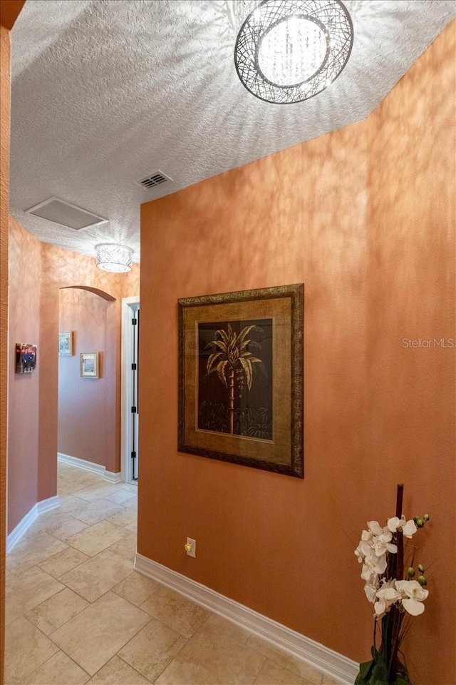 11502 Waterstone Loop Dr, Windermere, FL 34786 - corridor with a textured ceiling, attic access, and baseboards