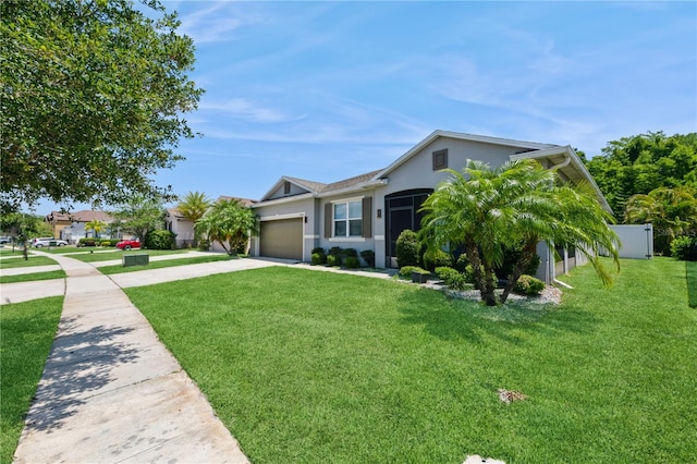 2952 Boating Blvd, Kissimmee, FL 34746 - ranch-style house featuring fence, a garage, stucco siding, a front yard, and concrete driveway