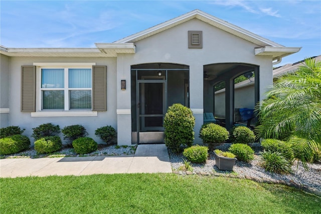 2952 Boating Blvd, Kissimmee, FL 34746 - entrance to property featuring a lawn and stucco siding