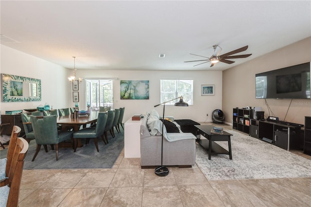 2952 Boating Blvd, Kissimmee, FL 34746 - living area with light tile patterned flooring, visible vents, plenty of natural light, and ceiling fan with notable chandelier