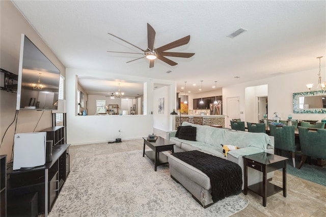 2952 Boating Blvd, Kissimmee, FL 34746 - tiled living room featuring visible vents and ceiling fan with notable chandelier