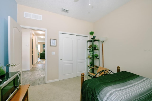 2952 Boating Blvd, Kissimmee, FL 34746 - bedroom with baseboards, a closet, light colored carpet, and visible vents