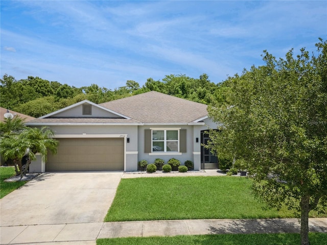 2952 Boating Blvd, Kissimmee, FL 34746 - ranch-style house with roof with shingles, an attached garage, stucco siding, a front yard, and driveway