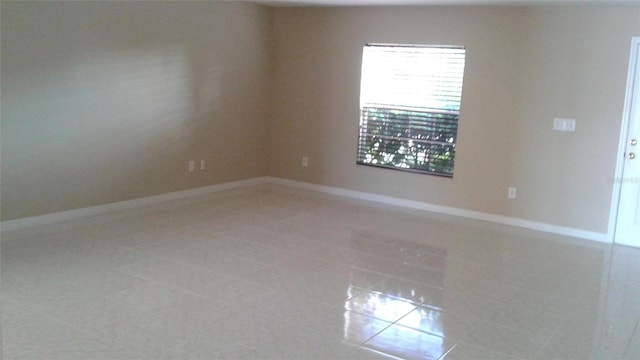 2011 N 61st St, Tampa, FL 33619 - spare room with light tile patterned flooring and baseboards
