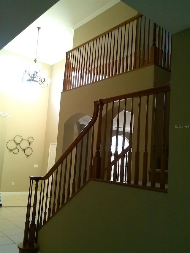 2011 N 61st St, Tampa, FL 33619 - staircase with a chandelier, baseboards, and tile patterned floors