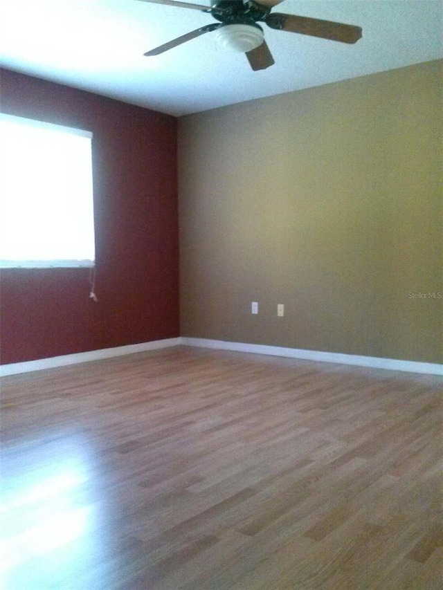 2011 N 61st St, Tampa, FL 33619 - empty room featuring wood finished floors, a ceiling fan, and baseboards