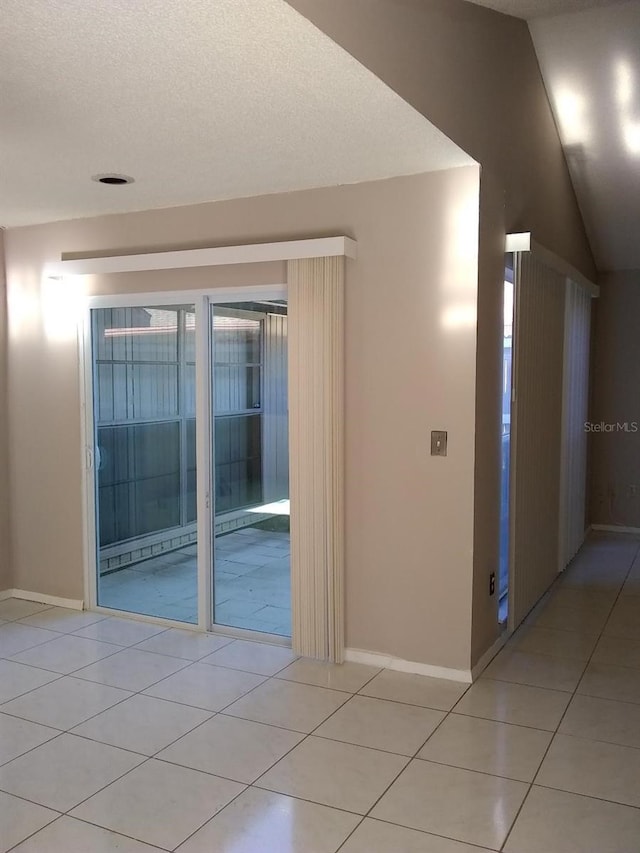 2011 N 61st St, Tampa, FL 33619 - unfurnished room with light tile patterned floors, baseboards, and a textured ceiling