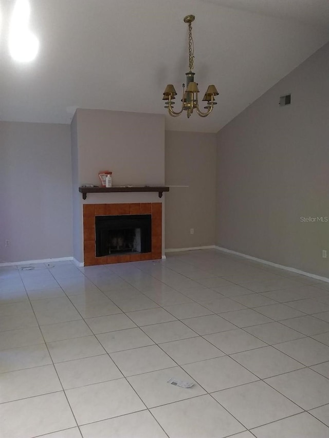 2011 N 61st St, Tampa, FL 33619 - unfurnished living room featuring a tile fireplace, a chandelier, lofted ceiling, baseboards, and light tile patterned flooring