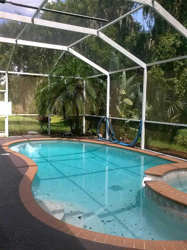 2011 N 61st St, Tampa, FL 33619 - view of pool featuring a lanai and a pool with connected hot tub