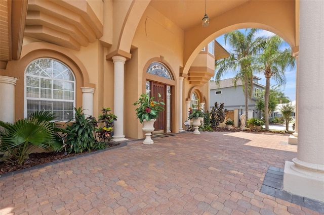 view of exterior entry with stucco siding