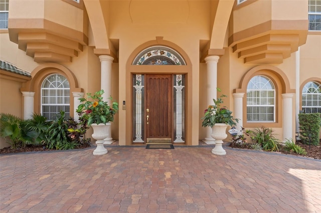 entrance to property featuring stucco siding