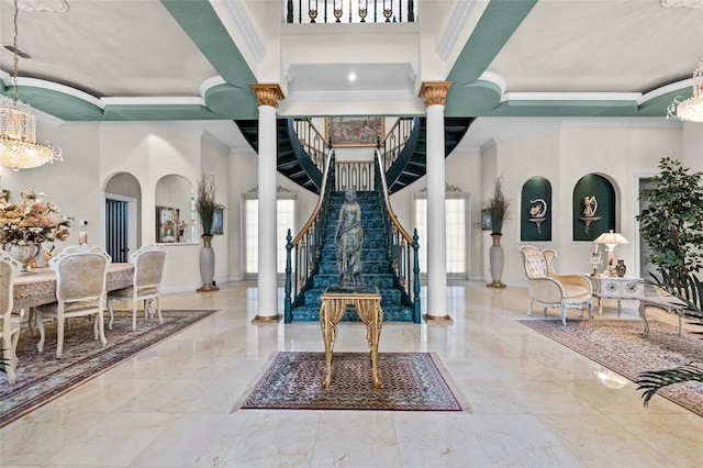 interior space featuring crown molding, marble finish floor, and a notable chandelier