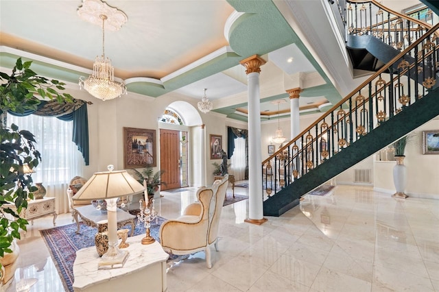 interior space featuring crown molding, a notable chandelier, a healthy amount of sunlight, and stairway