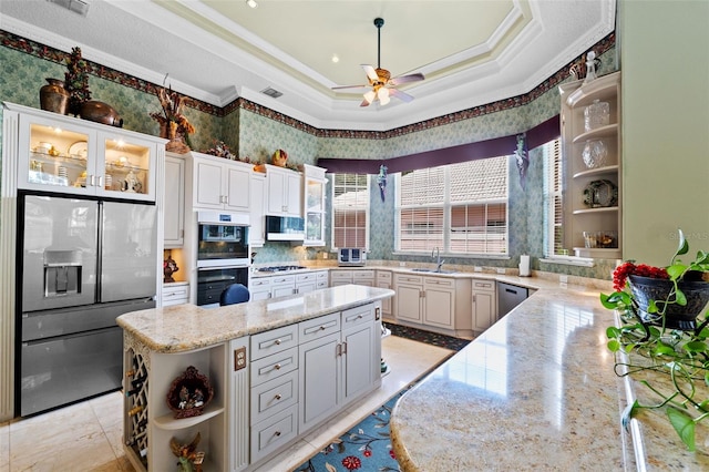kitchen with a ceiling fan, crown molding, appliances with stainless steel finishes, a center island, and open shelves